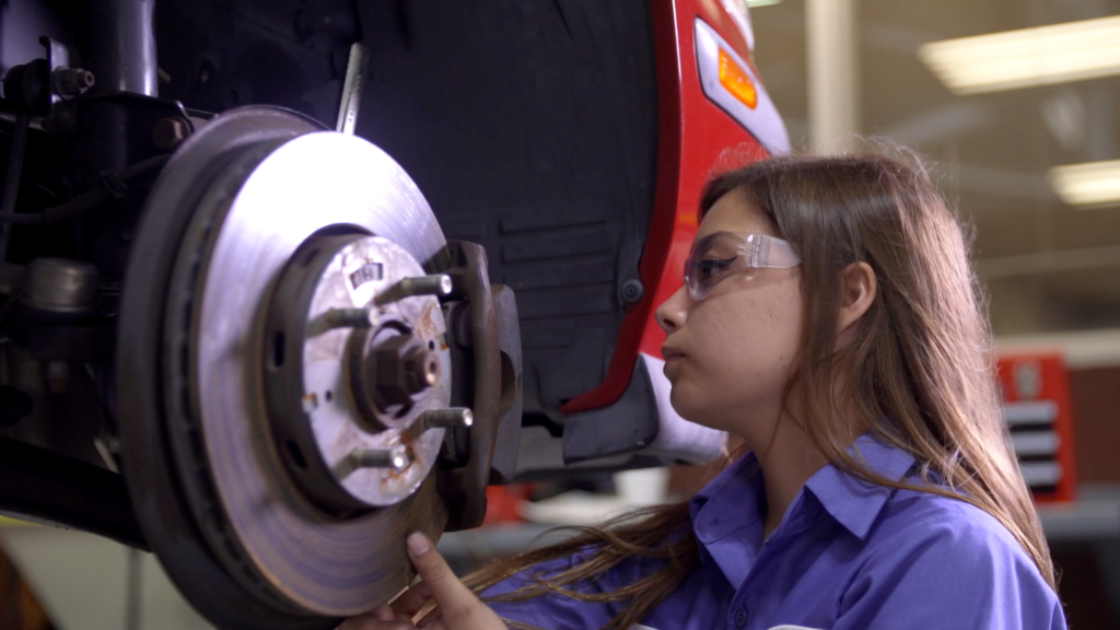 A student working on a car brake system.